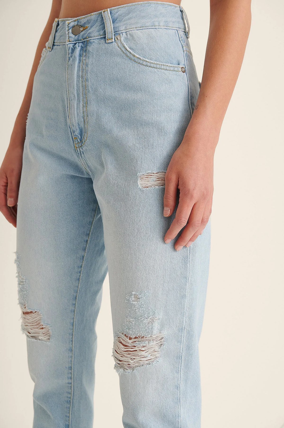 Close-Up of Ripped Detailing on Light Blue Mom Jeans