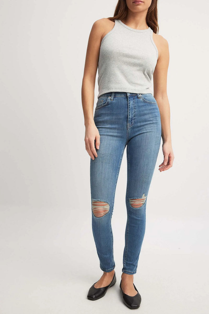 Front View of Mid Blue Skinny High Waist Destroyed Jeans – Mid blue skinny jeans with destroyed detailing, front view.